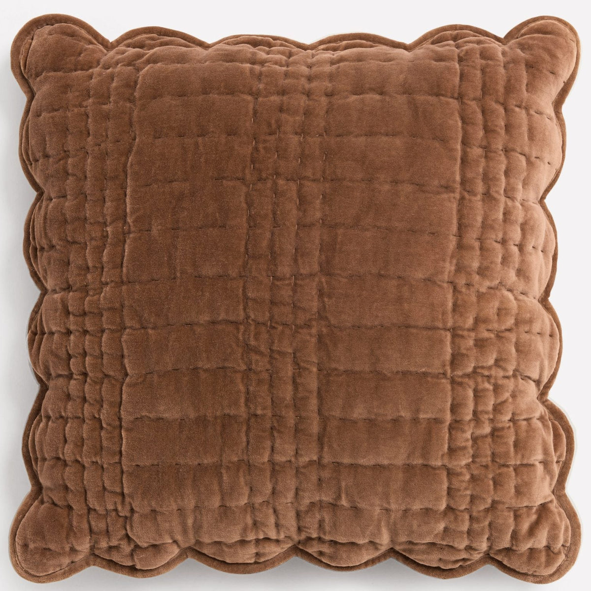Brown quilted velvet cushion with scalloped edges