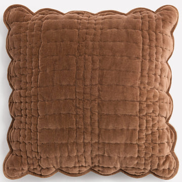 Brown quilted velvet cushion with scalloped edges