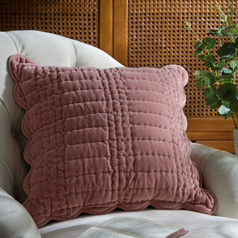 Dusty pink velvet textured square cushion on a cream armchair